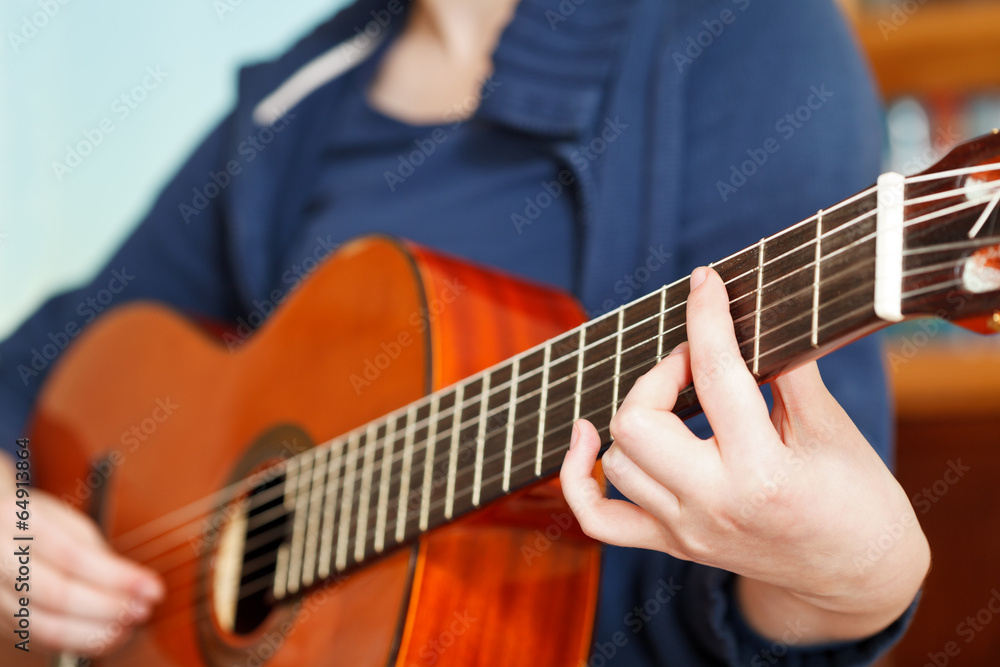 girl playing classical acoustic guitar