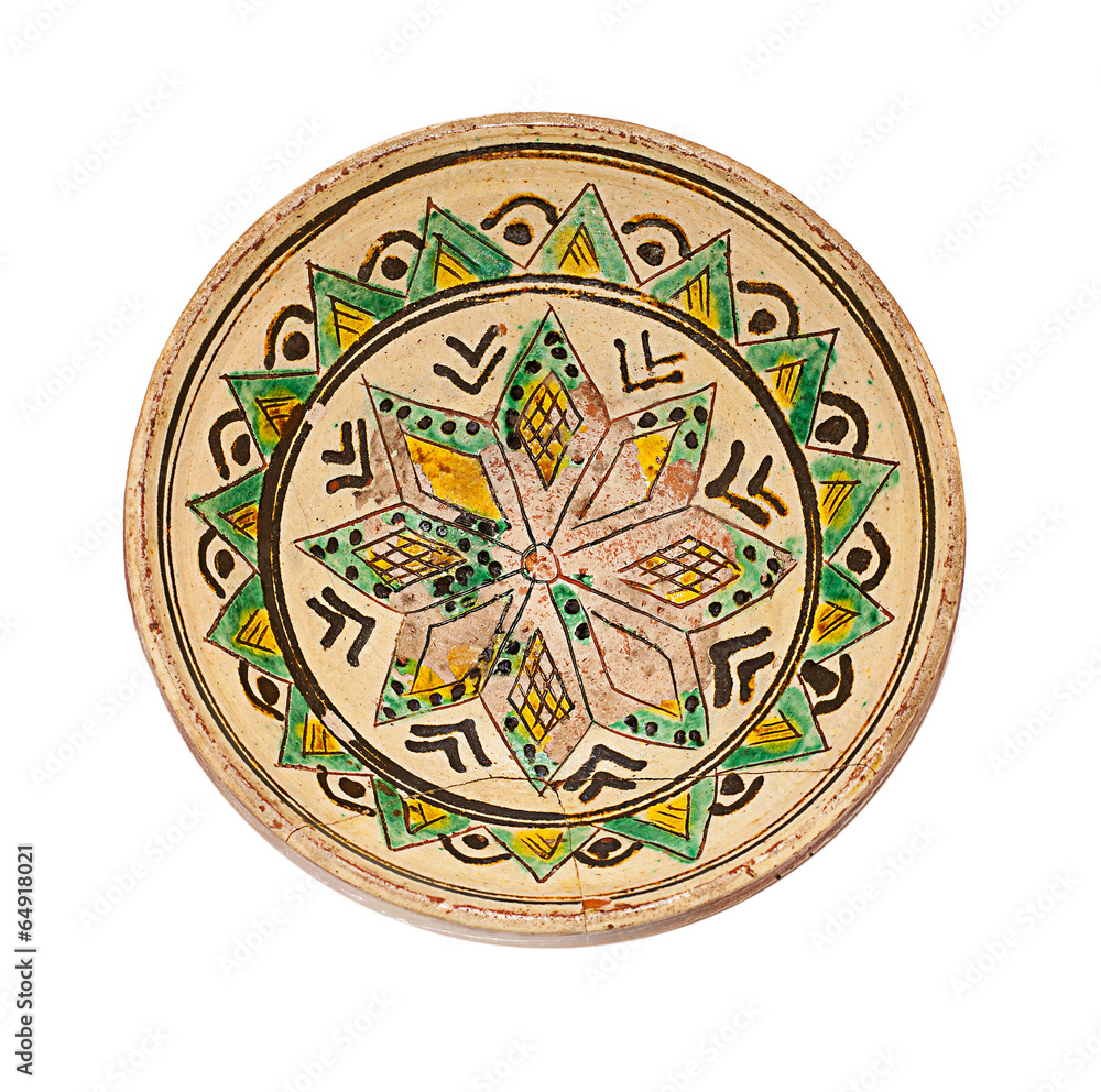 ancient plate from ceramics with ornament on a white background