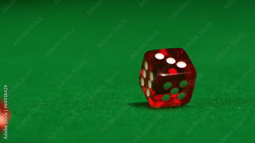 Red dice rolling on casino table Red dice rolling on casino table