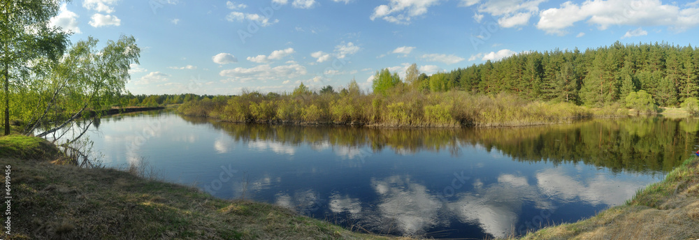 May panorama quiet forested river.