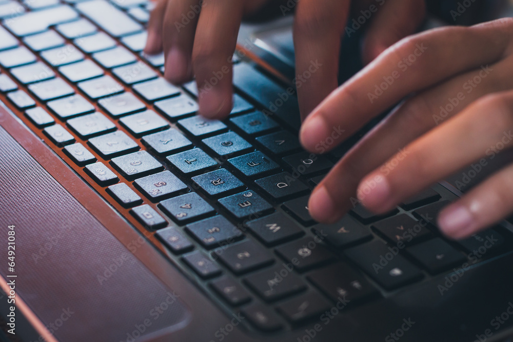 Detail of hands working on computer keyboard Detail of hands working on computer keyboard