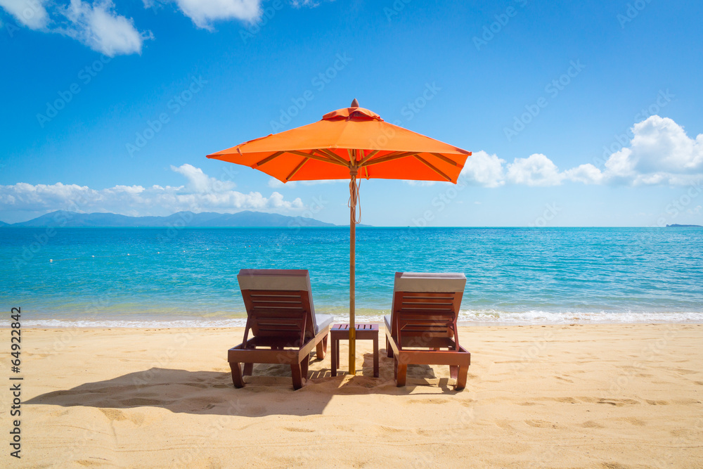 Fototapeta premium Two lounge chairs on the beach