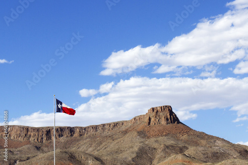 Texas State Flag with Blue Sky and Rock Mesa photo