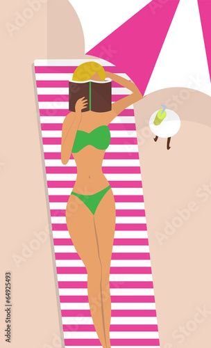 A woman reading a book at the beach