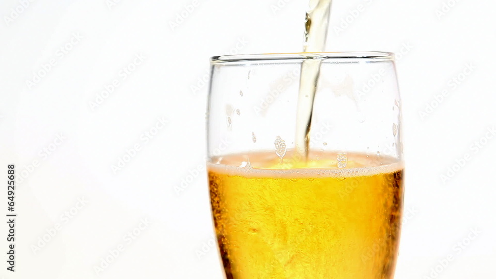 Beer glass being refiled (isolated on white background) Beer glass being refiled (isolated on white background)