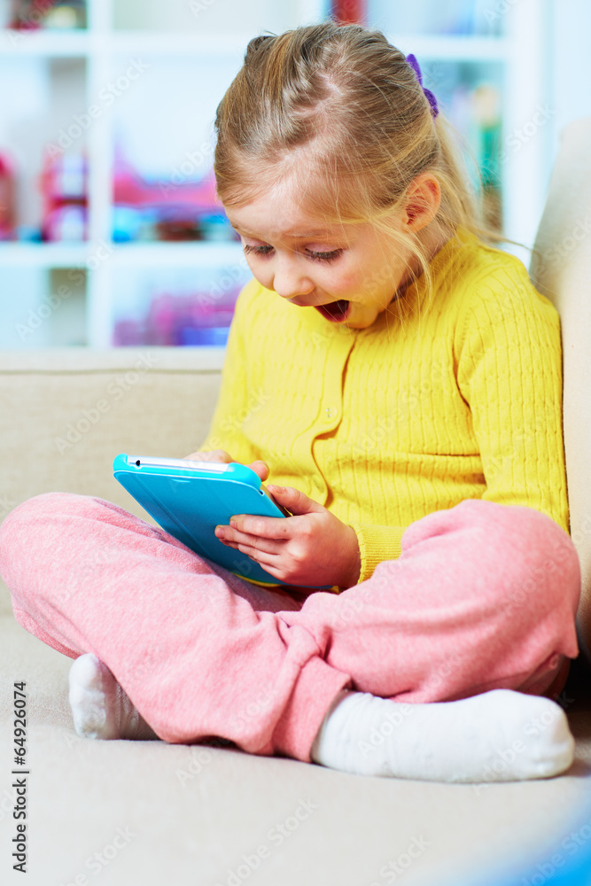 Little girl game play in tablet Little girl game play in tablet