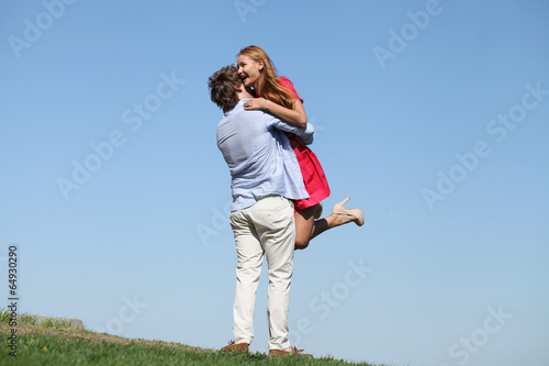 Young happy couple on blue sky