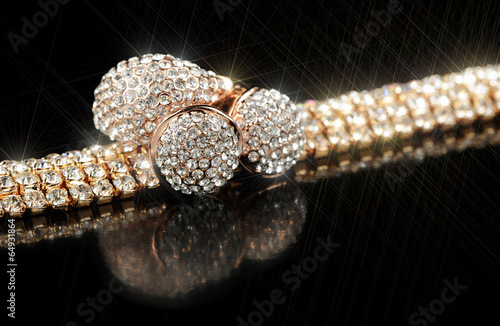 Cuadro en lienzo Shiny Gold Bracelet, Earrings and Ring on Black Background