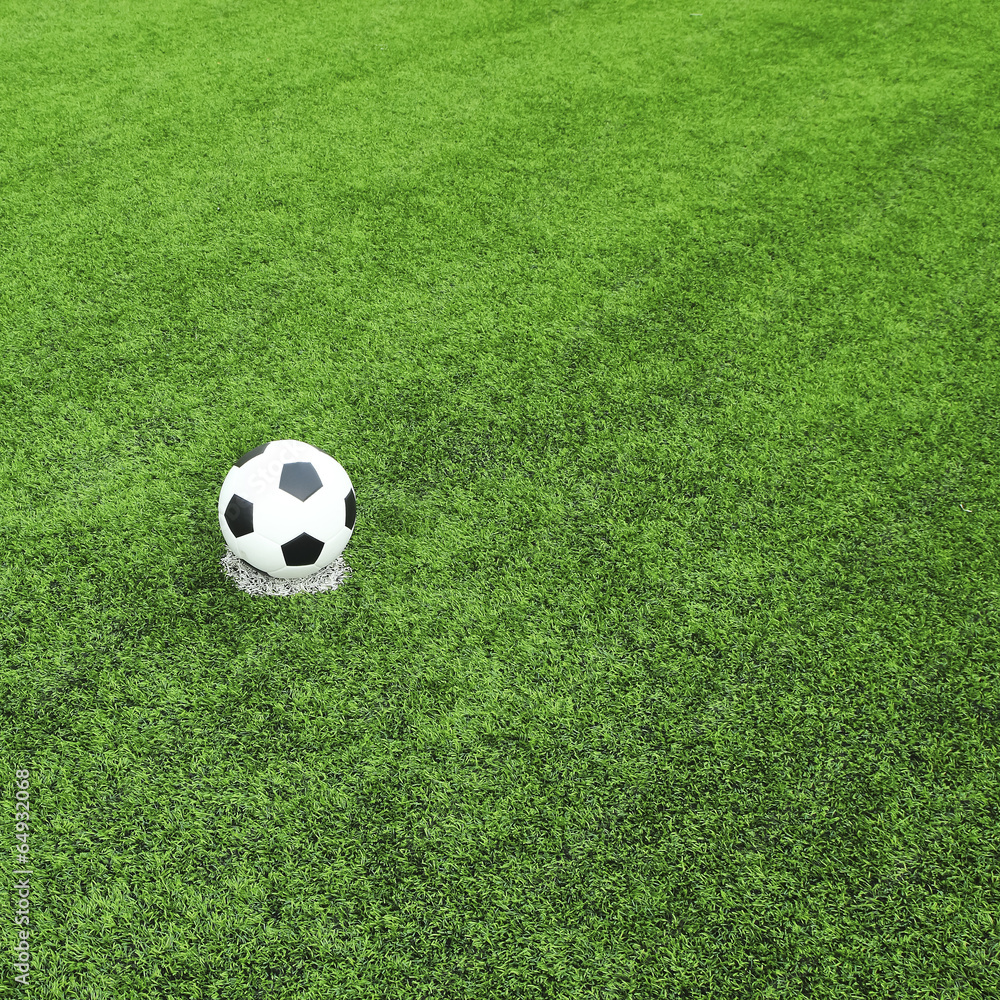 view of green striped football field with soccer ball view of green striped football field with soccer ball