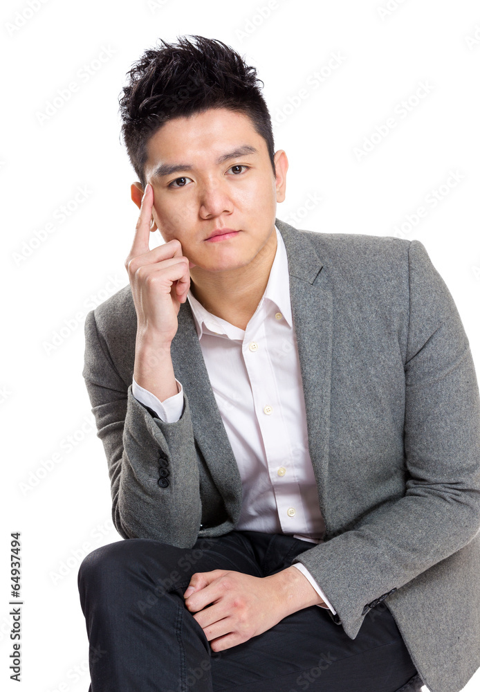 Asian businessman thinking and sitting on chair Asian businessman thinking and sitting on chair