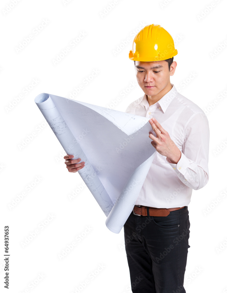 Asia construction engineer reading on blueprint Asia construction engineer reading on blueprint