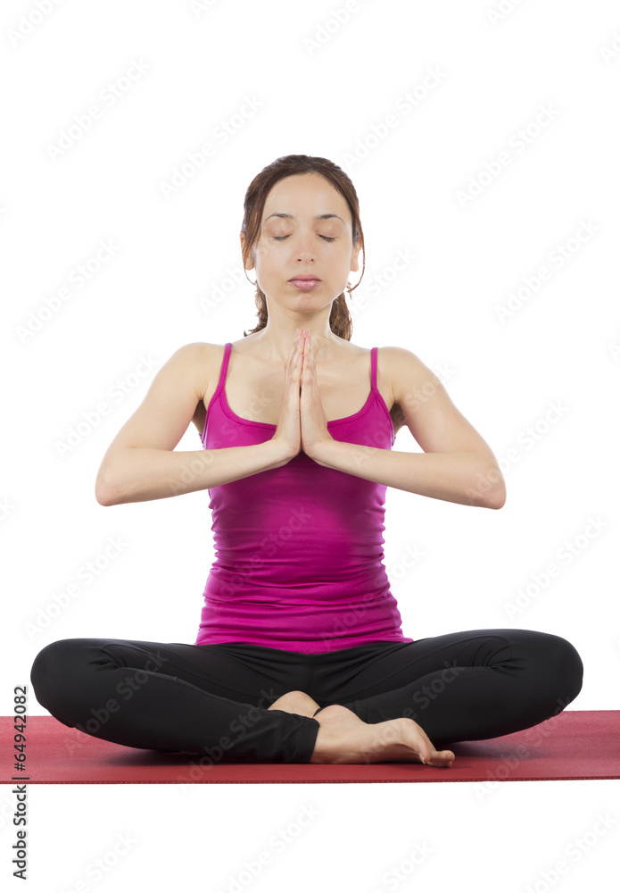 Young woman meditating in a seated position Young woman meditating in a seated position