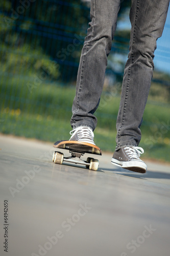 Legs in sneakers on a skateboard