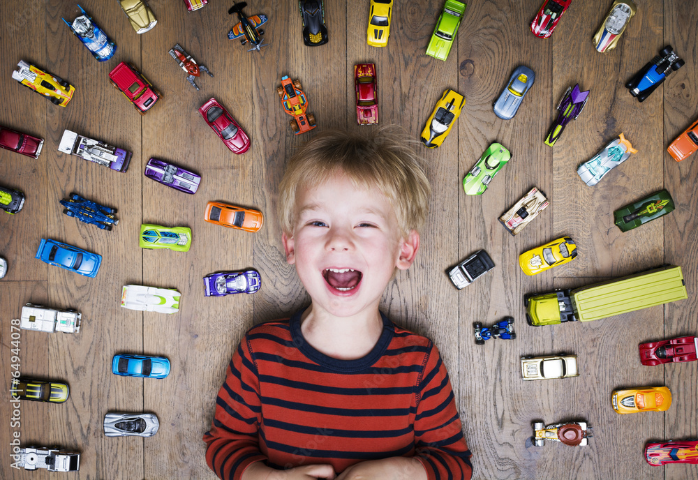 Naklejka premium Boy with his toy car collection