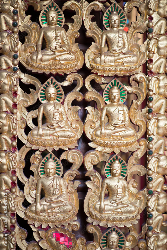 Fototapeta premium Buddha and disciples carved wood of temple gate.