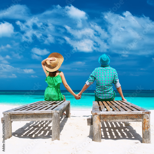 Couple in green on a beach at Maldives © haveseen