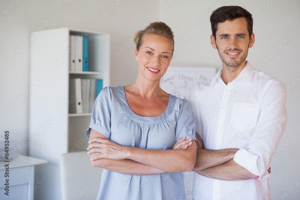 Casual business team smiling at camera with arms crossed Casual business team smiling at camera with arms crossed