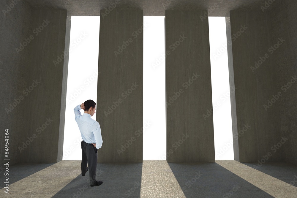 Fototapeta premium Composite image of thinking businessman scratching head