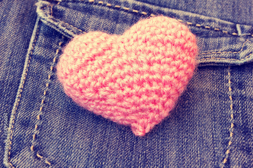 knitted pink valentine s heart on a vintage jeans background