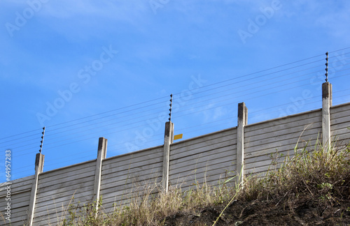 Electric Security Fence Atop a Precast Wall