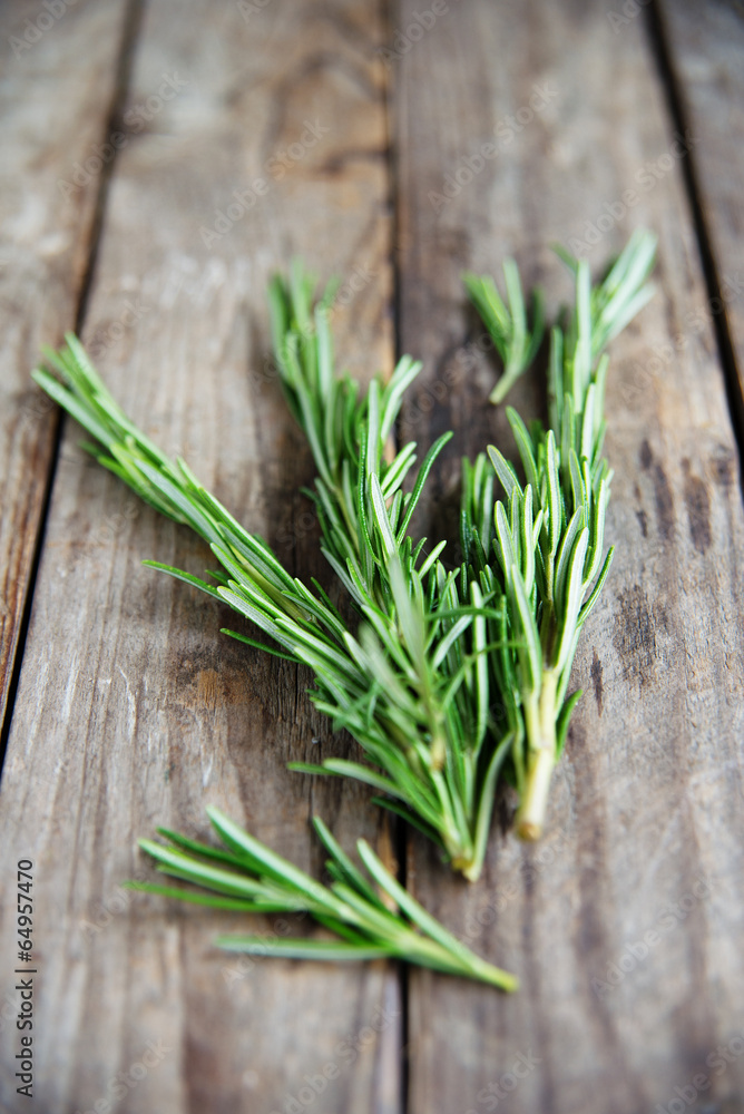 fresh rosemary bunch on an old rustic wooden table fresh rosemary bunch on an old rustic wooden table