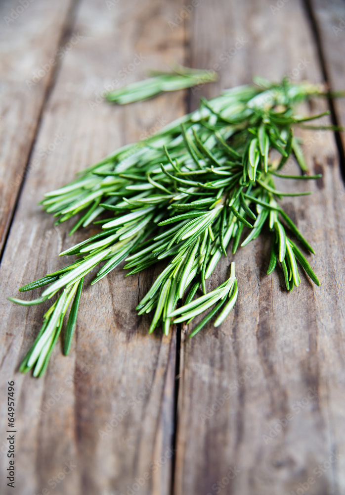 fresh rosemary bunch on an old rustic wooden table - obrazy, fototapety, plakaty 