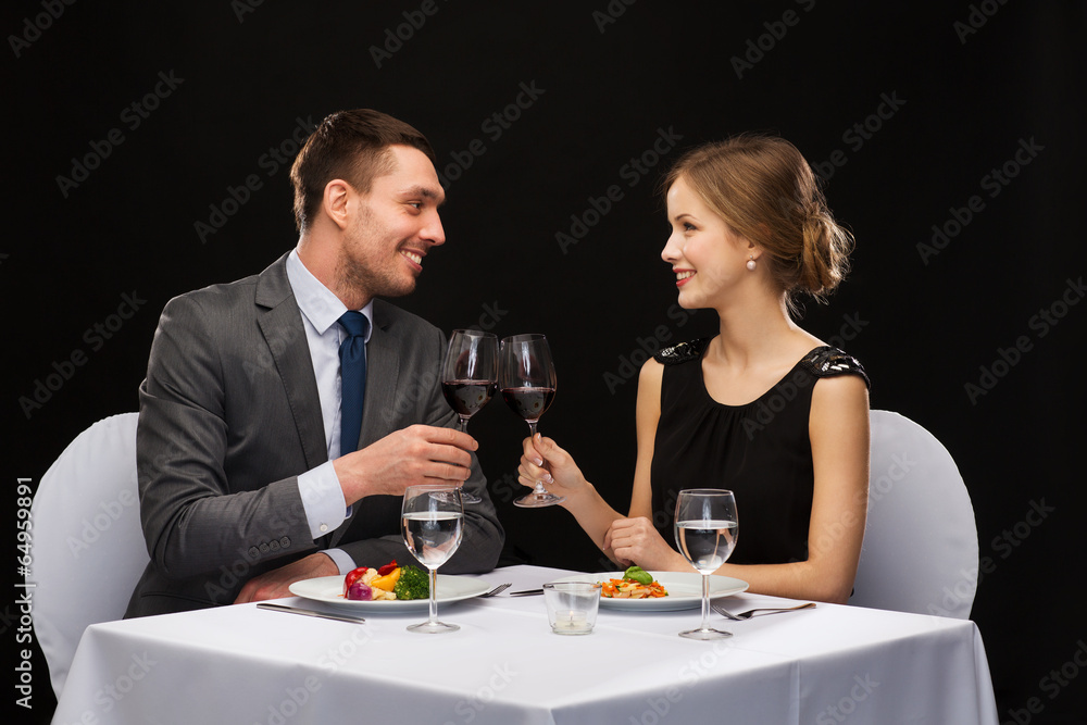 smiling couple eating main course at restaurant smiling couple eating main course at restaurant