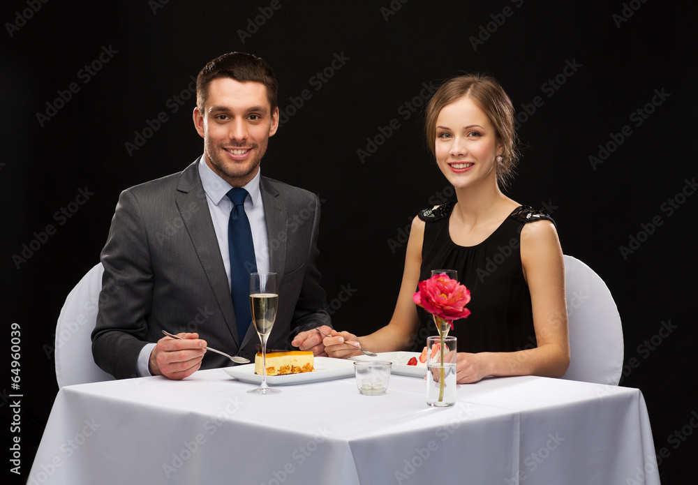 smiling couple eating dessert at restaurant smiling couple eating dessert at restaurant