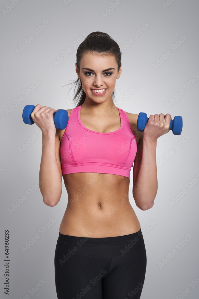 Happy woman training with dumbbells Happy woman training with dumbbells