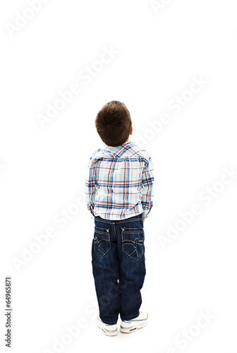 Back view of little boy looking at wall. Rear view