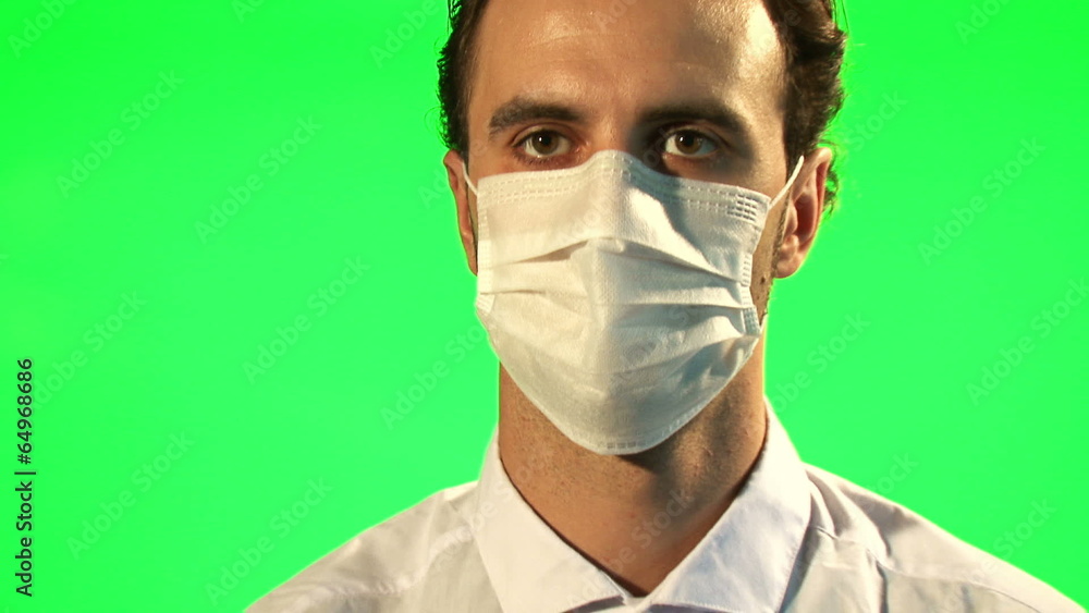 Doctor puts on mask and surgical gloves - green screen Doctor puts on mask and surgical gloves - green screen