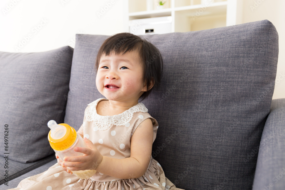Asia baby girl holding milk bottle Asia baby girl holding milk bottle