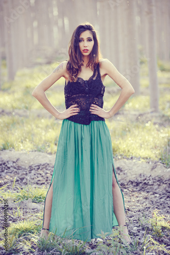 Woman wearing long dress in a forest