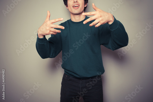 Young man thinks he is cool and is gesturing with his hands photo