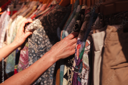 Woman browsing clothes at market