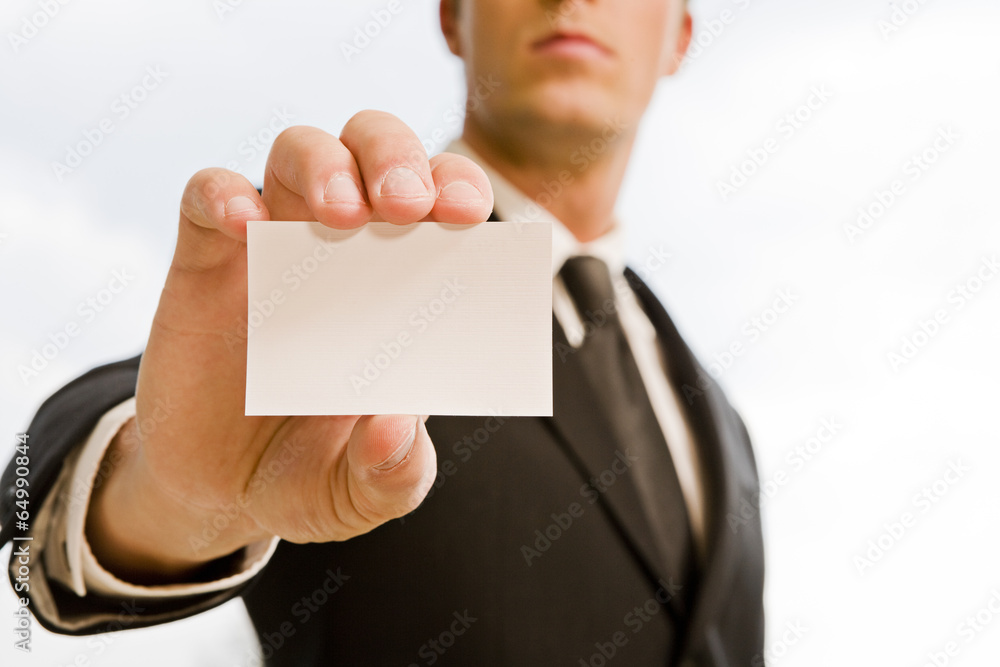 Man's hand showing business card. Black suit and tie. Man's hand showing business card. Black suit and tie.