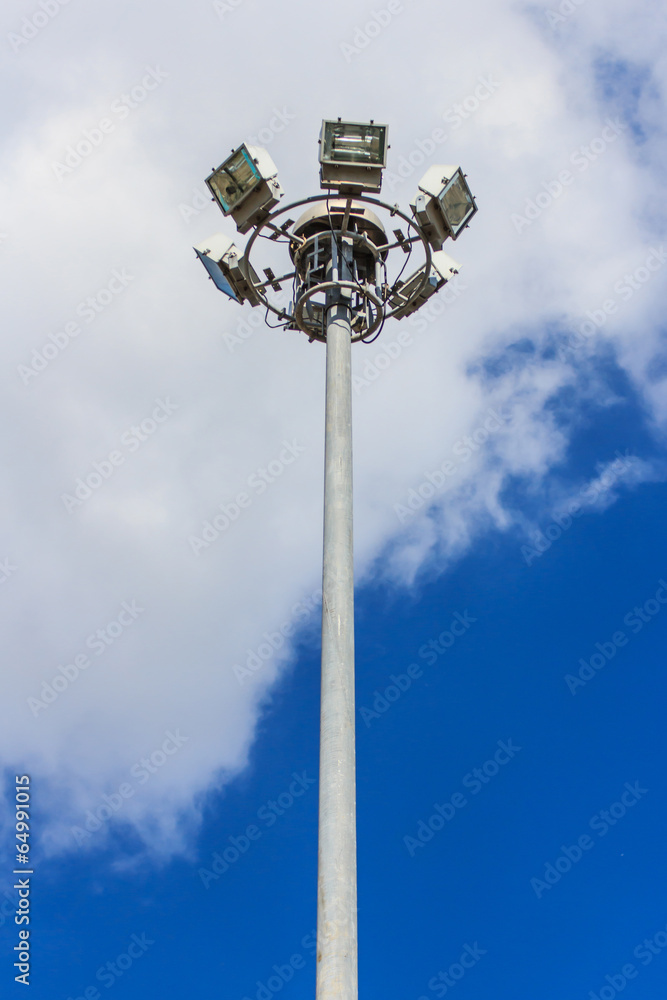 Spotlight pole blue sky cloud