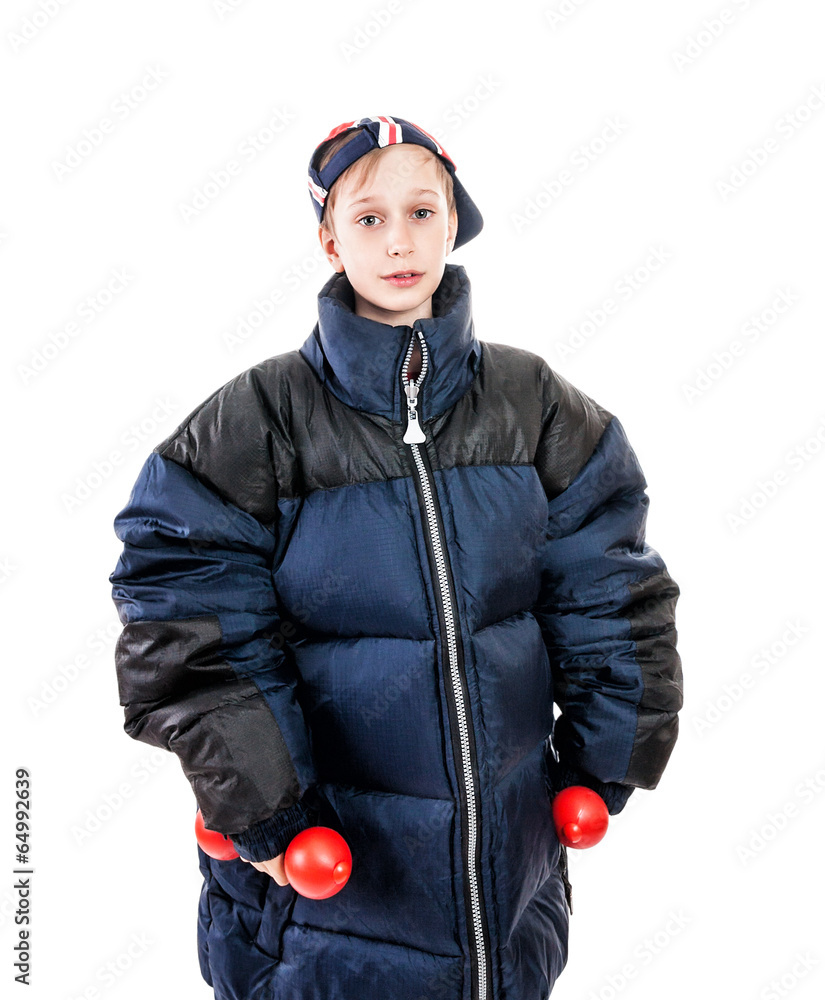 funny child wearing big jacket and cap holding dumbells Stock