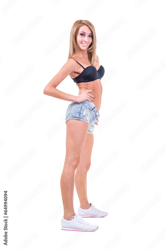 Pretty woman posing in sexy jeans shorts. Isolated on white Pretty woman posing in sexy jeans shorts. Isolated on white