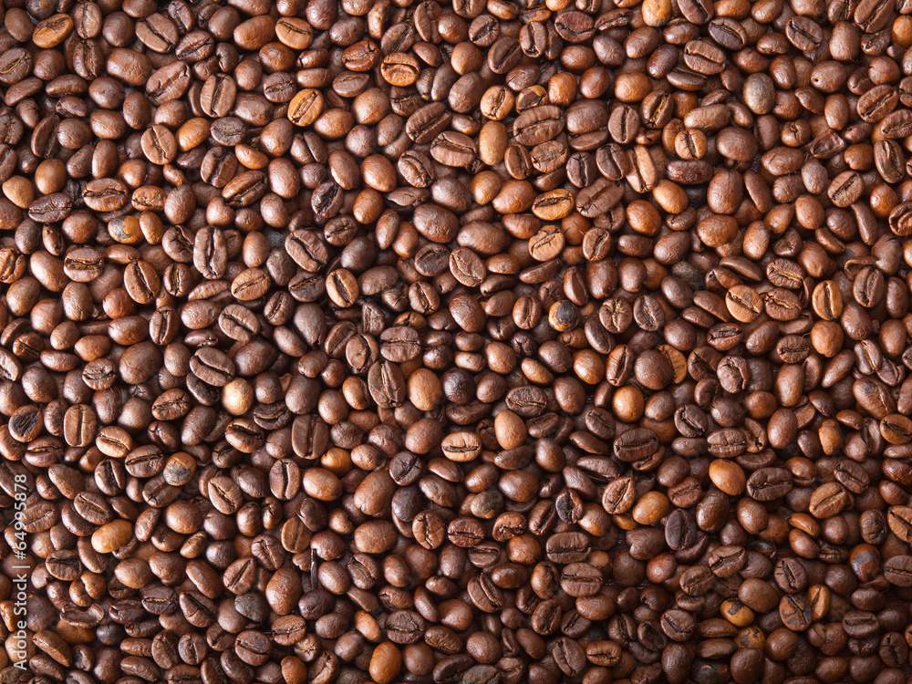 Numerous coffee beans which have been scattered all over the sur Numerous coffee beans which have been scattered all over the sur