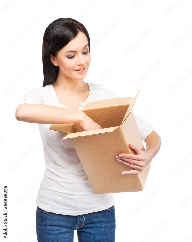 Young and attractive girl with a cardboard box isolated on white Young and attractive girl with a cardboard box isolated on white