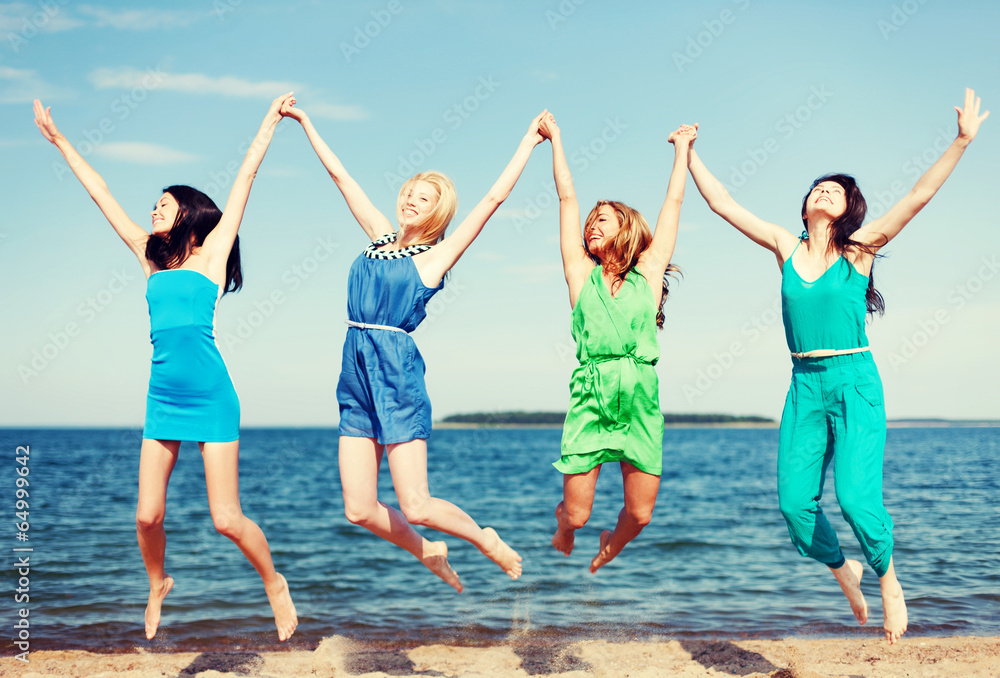 Obraz premium girls jumping on the beach
