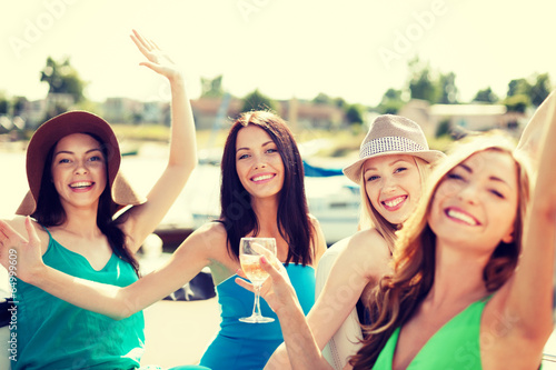 girls with champagne glasses on boat