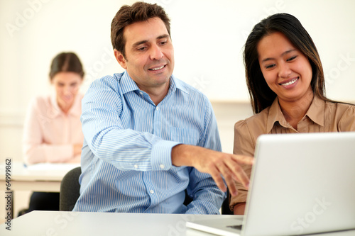 Attractive young couple working on laptop