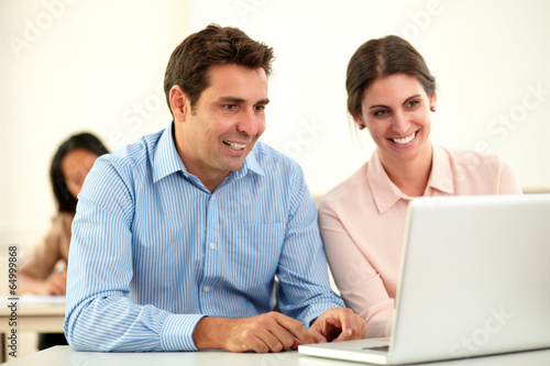Man and woman working on laptop