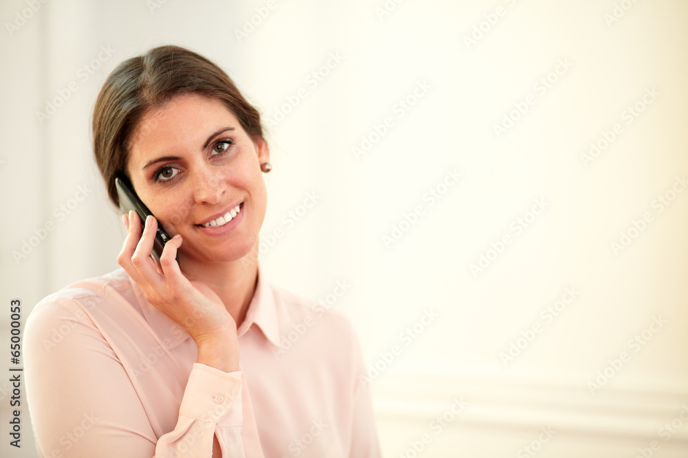 Professional young woman speaking on her cellphone Professional young woman speaking on her cellphone