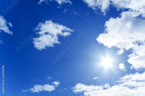 blue sky with white clouds and the sun