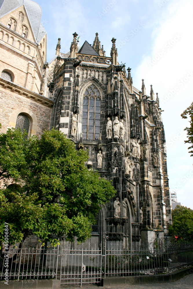 Side view of a church, with statues on the façade Side view of a church, with statues on the façade