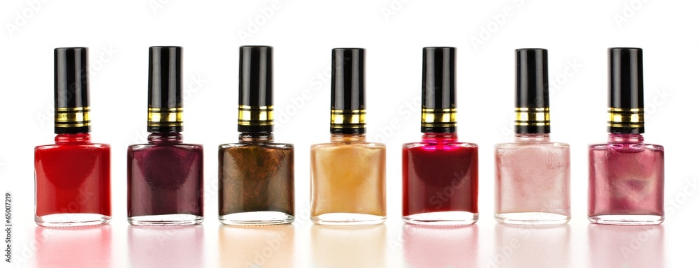 Row of varied red tone nail polish bottles Row of varied red tone nail polish bottles