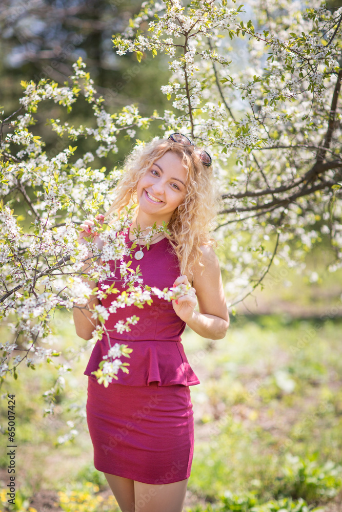 Charming young girl in the spring cherry blossoms Charming young girl in the spring cherry blossoms